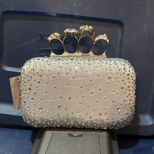 Silver skull brass knuckle style clutch